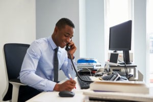 Man smiling while talking on the phone
